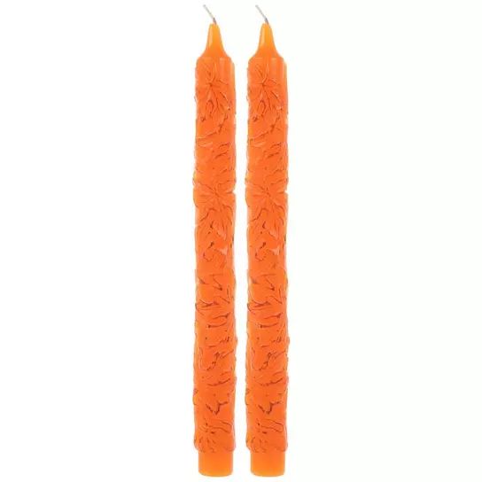 two orange candles sitting next to each other