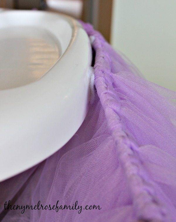 a white plate with a purple tulle around it