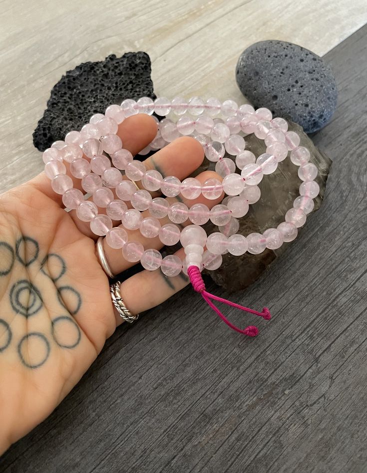 This rose quartz mala necklace has a light pink tone that will be easy to match your everyday outfits and keep you calm and grounded if you use it while meditating. Its a unique decor item also. A perfect gift for a yoga lover, or someone that loves stones. You can use it as a necklace or wrap it around the wrist and becomes a bracelet. The Mala necklace has a drop length of 43cm- 17 inch. A most have addition to your jewelry collection. ⚡️Join Akashi's VIP list for early bird discount access⚡️ Beaded Rose Quartz Crystal Necklace, Adjustable Rose Quartz Round Bead Necklace, Adjustable Rose Quartz Necklace With Round Beads, Rose Quartz Necklace With Gemstone Beads For Meditation, Pink Jewelry For Meditation, Rose Quartz 108 Beads Jewelry For Meditation, Pink Spiritual Beaded Necklace With Gemstone Beads, Adjustable Rose Quartz Beaded Necklace As Gift, Adjustable Rose Quartz Beaded Necklace For Gift