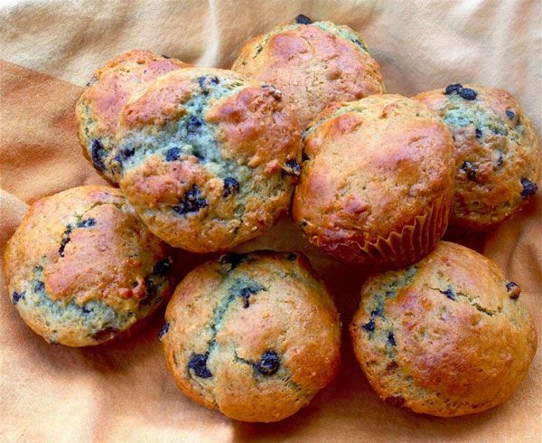 a pile of blueberry muffins sitting on top of a cloth