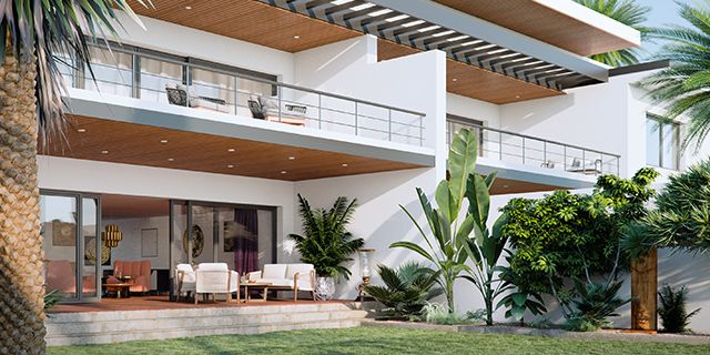 a large white house with palm trees in the front yard and patio area on top of it