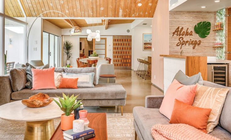 a living room filled with furniture and lots of windows