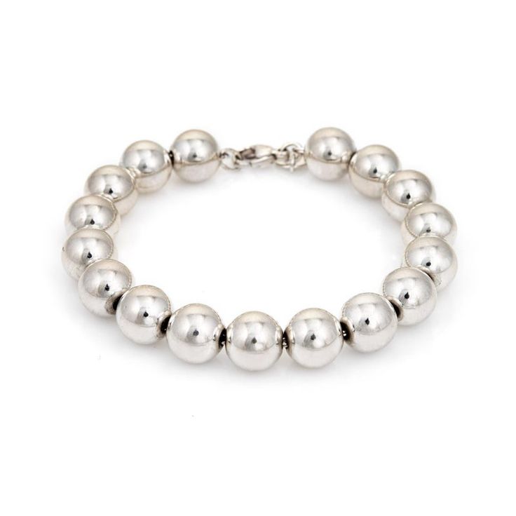 Stylish pre-owned Tiffany & Co graduated silver bead bracelet crafted in 925 sterling silver.    The bracelet features silver beads that are uniform in size (10mm). Great worn alone or layered with your fine jewellery from any era.  The bracelet is in very good condition and was recently professionally cleaned and polished.   Particulars:  Weight: 18.9 grammes  Stones:  N/A.     Size & Measurements: The bracelet measures 7 inches in length.   Metal & Hallmark: Sterling silver. The bracelet is ha Classic Silver Beaded Jubilee Bracelet, Classic Sterling Silver Bracelets With Spacer Beads, Classic Sterling Silver Bracelet With Beads, Classic Sterling Silver Bracelet With Polished Beads, White Gold Beaded Jubilee Bracelet, Classic Sterling Silver Bracelet With Spacer Beads, Classic Sterling Silver Bracelet With 8mm Beads, Classic Adjustable Sterling Silver Bracelet With Polished Beads, Classic Sterling Silver Polished Beads Bracelet