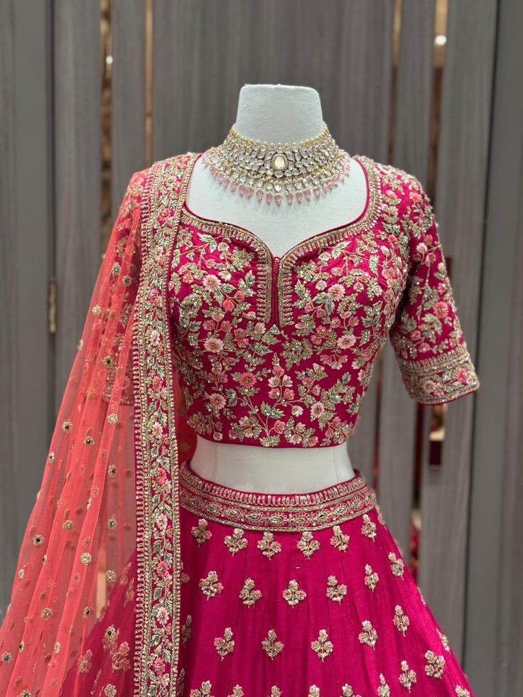 Unleash your bold side with our JUNE MADNESS ONLINE EXCLUSIVE- 013! This vibrant pink bridal wear features a stylish multicolor thread border with intricate butties all over the skirt. Complete the look with the peach orange dupatta, perfect for the daring sister of the bride or groom. Get ready to make a statement at any wedding or special occasion with this unique piece! Fabric: Raw Silk! WASH CARE INSTRUCTIONS - Please Dry clean only when it is applicable. Ready to Ship! Designer Embellished Raw Silk Choli, Designer Embroidered Lehenga In Chinon, Embellished Raw Silk Choli For Designer Wear, Designer Embroidered Chinon Lehenga, Designer Wear Pink Silk Thread Choli, Pink Silk Thread Lehenga For Festive Occasions, Pink Silk Thread Lehenga For Navratri, Bollywood Style Embellished Raw Silk Lehenga, Pink Silk Lehenga For Navratri