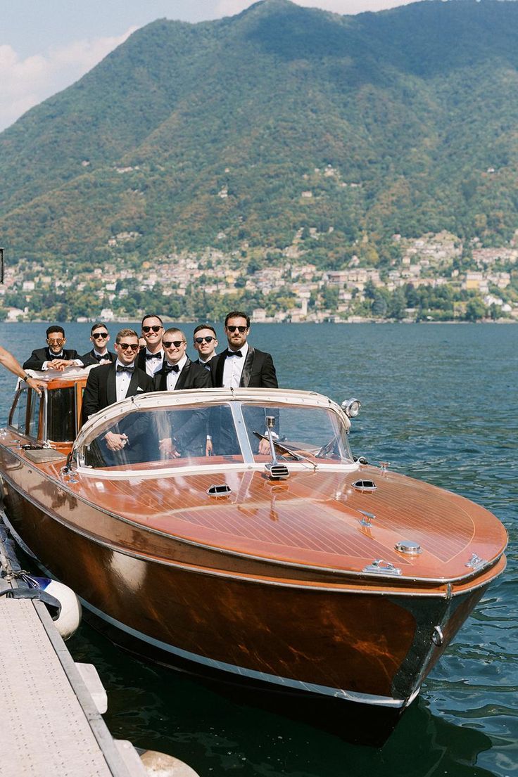 a group of men standing on top of a wooden boat