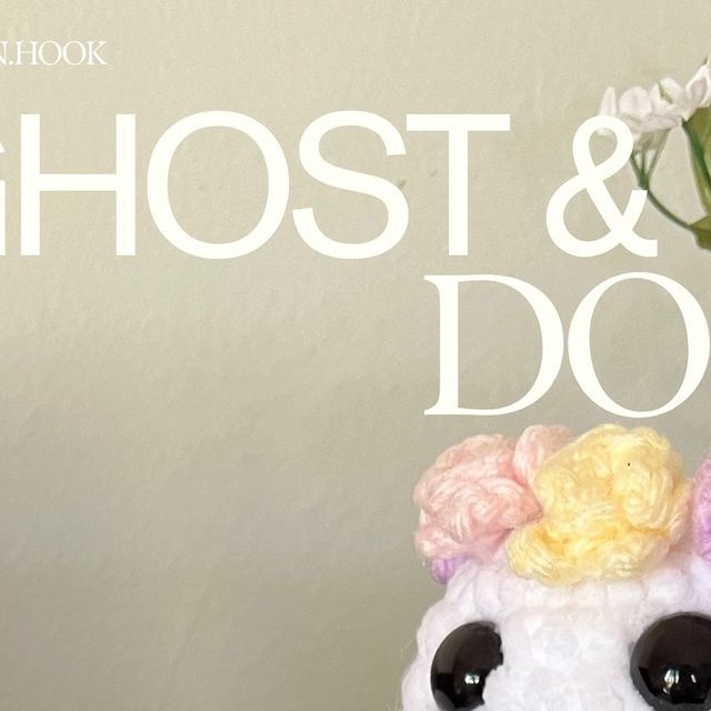 a crocheted stuffed animal with flowers in it's hair and the words ghost & dot written above it