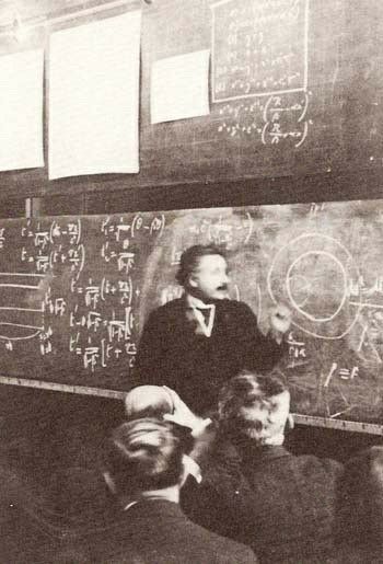 an old black and white photo of men in front of a chalkboard