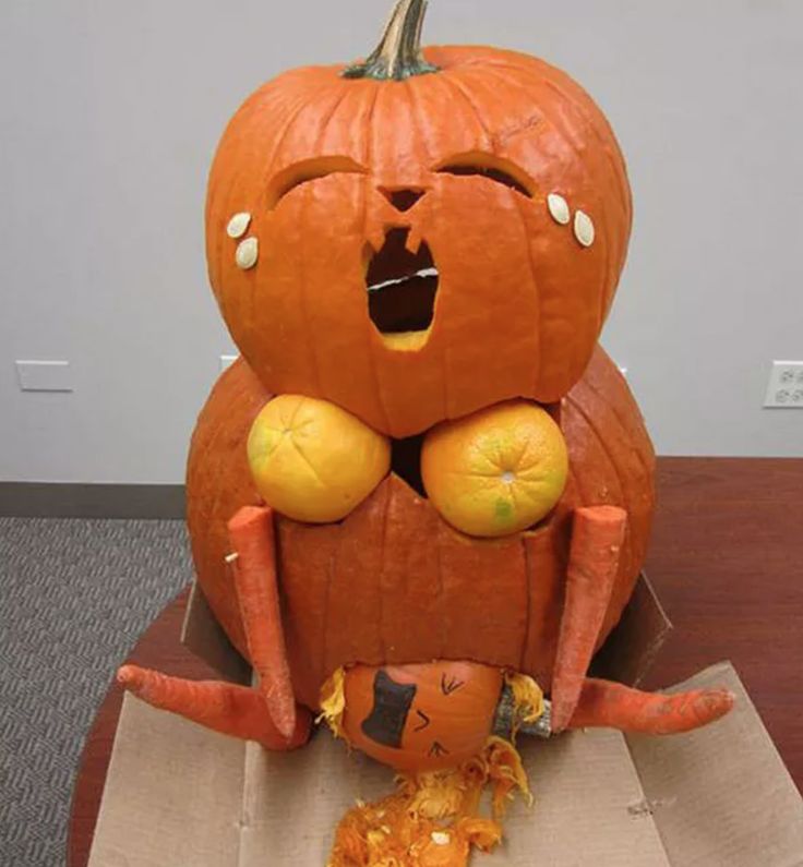 a carved pumpkin sitting on top of a cardboard box