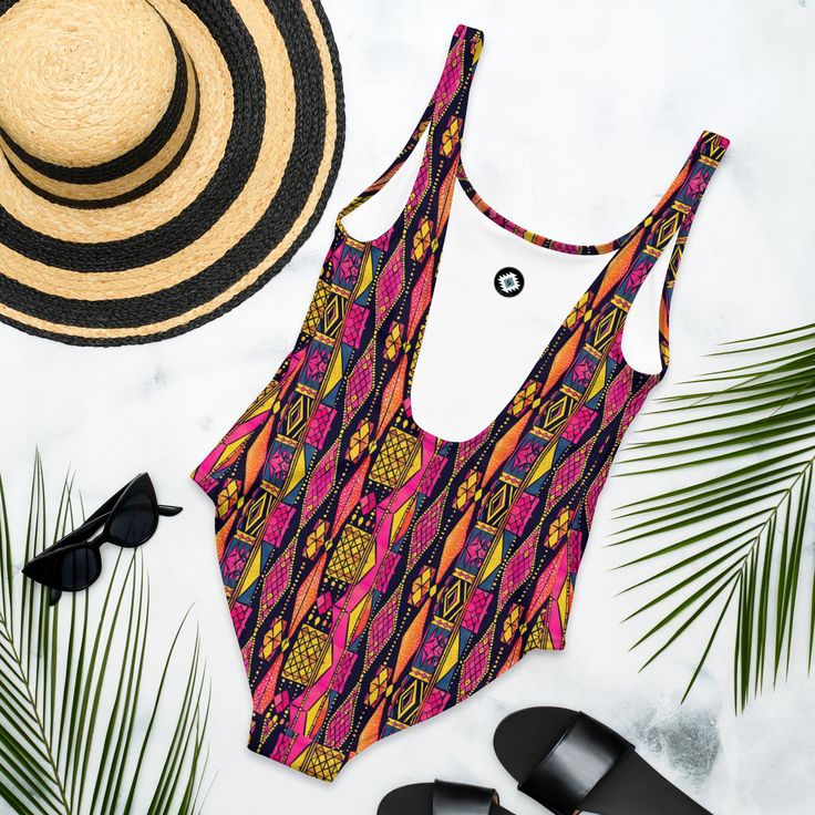 Inspired by the rich patterns of traditional Ghanaian Kente Cloth, this one-piece swimsuit is a standout choice for your beach days. With its vibrant pink design and flattering fit, it’s a fun and stylish way to show off your love for cultural patterns while enjoying the sun! This one-piece swimsuit for all figures will bring out your best features. Enjoy the smooth fabric and the flattering design, and show it off by the sea or pool! Trendy Printed One-piece Swimwear, Pink Tropical Swimwear With Vibrant Print, Tropical Pink Swimwear With Vibrant Print, Printed Bodysuit For Poolside Summer, Summer Poolside Printed Bodysuit, Printed Summer Bodysuit For Poolside, Pink One Piece For Summer Vacation, Pink Summer One Piece For Vacation, Pink One Pieces For Summer Vacation