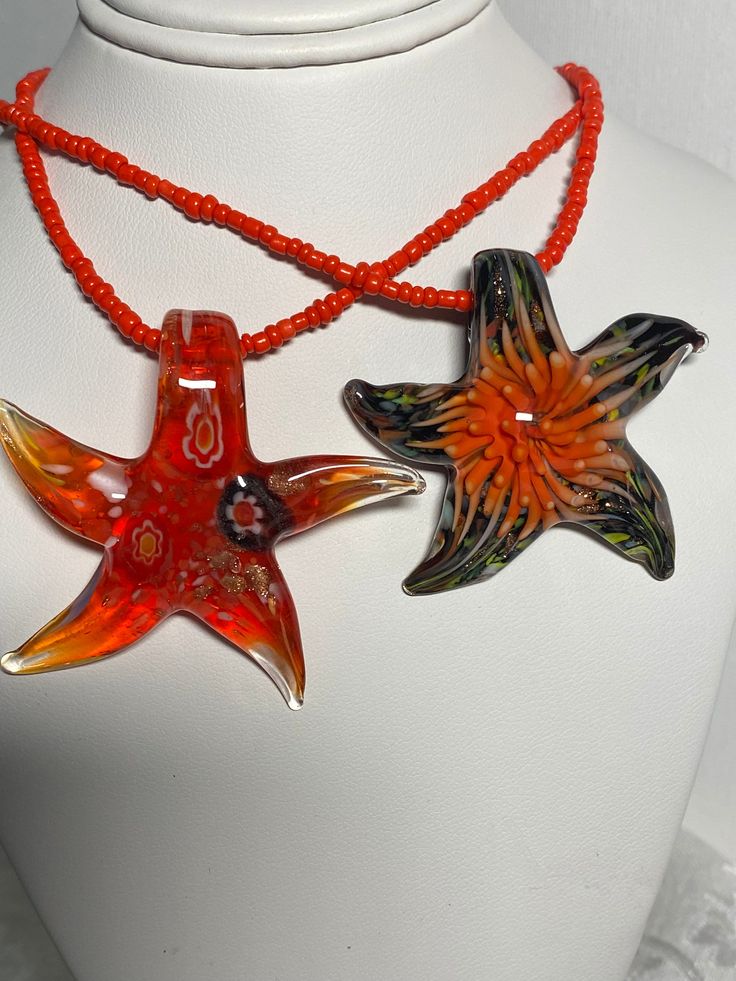 Murano glass starfish pendant, necklace, choker, clavicle, millefiore glass star,  red millet glass beaded cord, choker, clavicle, necklace each millefiore starfish glass pendant is unique in design, as well as the 3D floral coral design on the starfish shape. pendant height and width +/-  approximately 2 inches/5 cm glass beaded cord length: 38 cm + 9 cm extension/15.5 inches + 3.5 inch extension this item makes such a great gift with the unique design perfect for mother's day, birthday's, vale Handmade Starfish Beaded Necklaces As Gift, Starfish Charm Necklace With Round Beads For Gifts, Orange Glass Beaded Necklace For Gift, Starfish Shaped Beaded Necklaces For Gift, Starfish Shaped Beaded Necklace For Gift, Multicolor Starfish Necklace As Gift, Starfish-shaped Beaded Necklace For Gift, Ocean-inspired Strand Necklace With Starfish Charm, Starfish-shaped Colorful Beaded Jewelry For Gifts