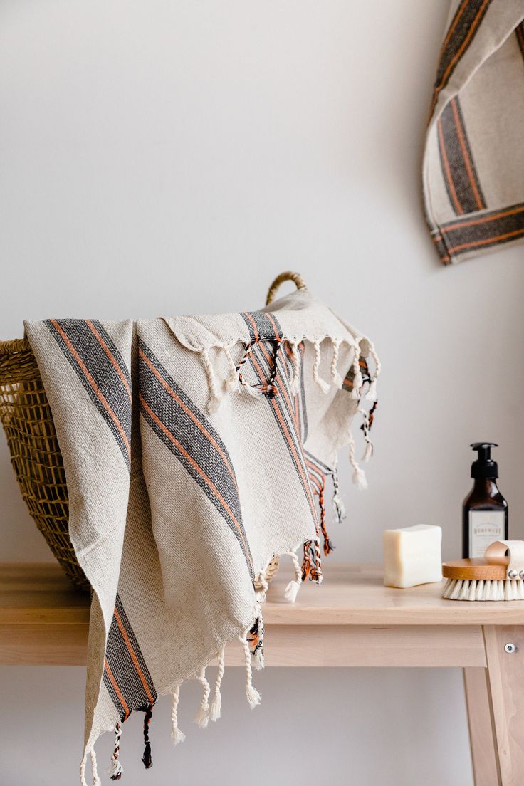 a towel is hanging on a shelf next to a bottle