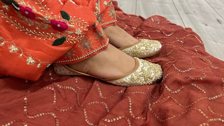 Introducing our exquisite collection of Punjabi Juttis, the perfect fusion of tradition and modern style. These are more than just shoes; they're a statement of cultural heritage and fashion-forward elegance. Our Punjabi Juttis are a celebration of Indian craftsmanship, carefully handcrafted to adorn the feet of brides, partygoers, and women who appreciate the beauty of ethnic footwear. Elegant Embellishments: Our Punjabi Juttis are a true embodiment of artistry. These party wear shoes are metic Zari Work Wedding Shoes, Zari Work Wedding Shoes For Festivals, Festive Zari Work Wedding Shoes, Ankle-length Traditional Wear With Zari Work, Wedding Shoes With Zari Work For Festivals, Wedding Shoes With Dori Work For Festivals, Wedding Shoes With Dori Work For Festive Occasion, Festive Ankle-length Traditional Wear For Wedding, Festive Wedding Shoes With Dori Work