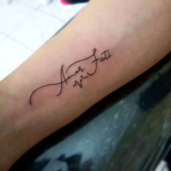 a tattoo with the word faith written in cursive writing