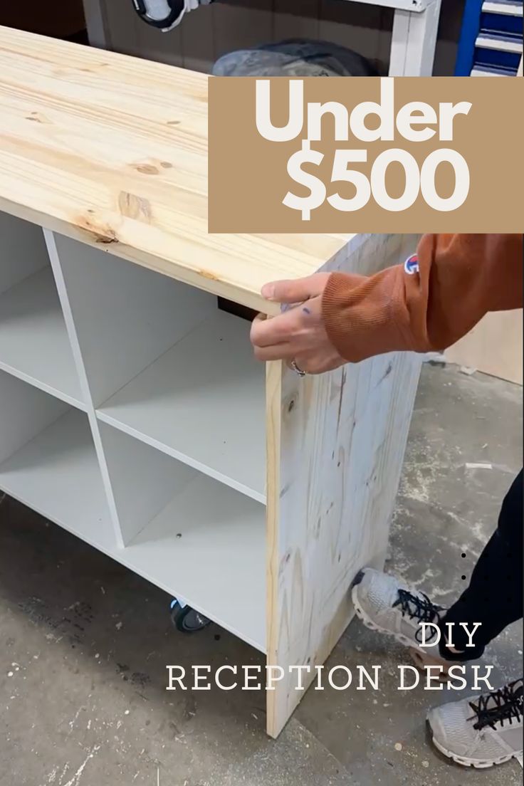 a person is working on a table with the words under $ 500 diy reception desk