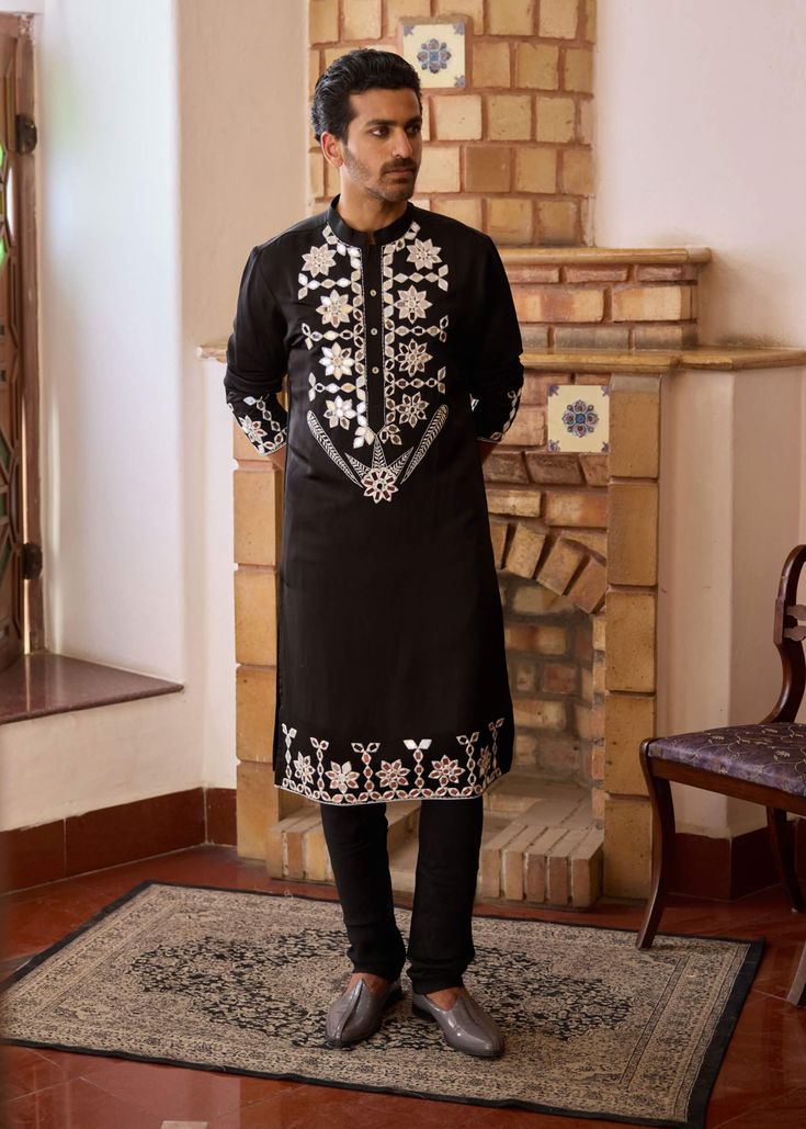 Elevate your style with this striking black kurta, adorned with intricate hand-embroidered mirror work. Made from premium viscose cotton silk, this kurta offers a luxurious feel while providing a smooth, comfortable texture. The delicate mirror work creates a captivating pattern, reflecting light and adding a touch of glamour to any festive occasion. Black Kurta, Reflecting Light, Bespoke Tailoring, Mirror Work, Churidar, Photographic Lighting, Elevate Your Style, Cotton Silk, Hand Embroidered