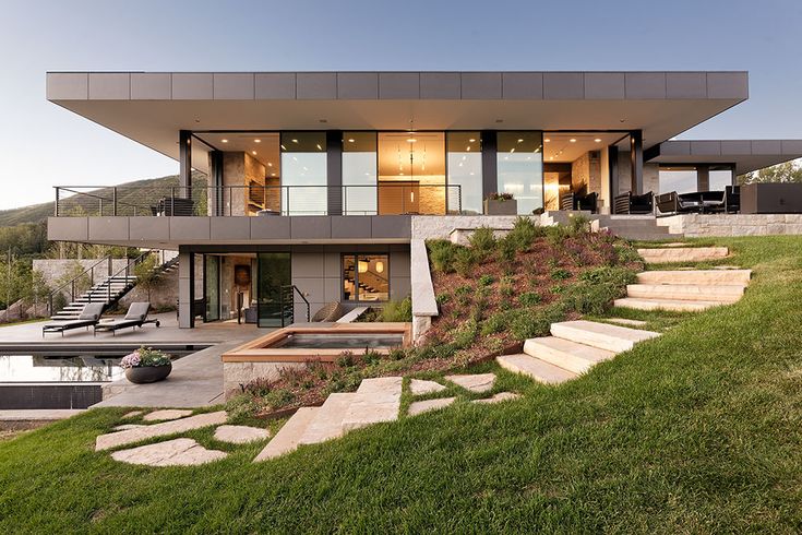 a modern house with stone steps leading up to it