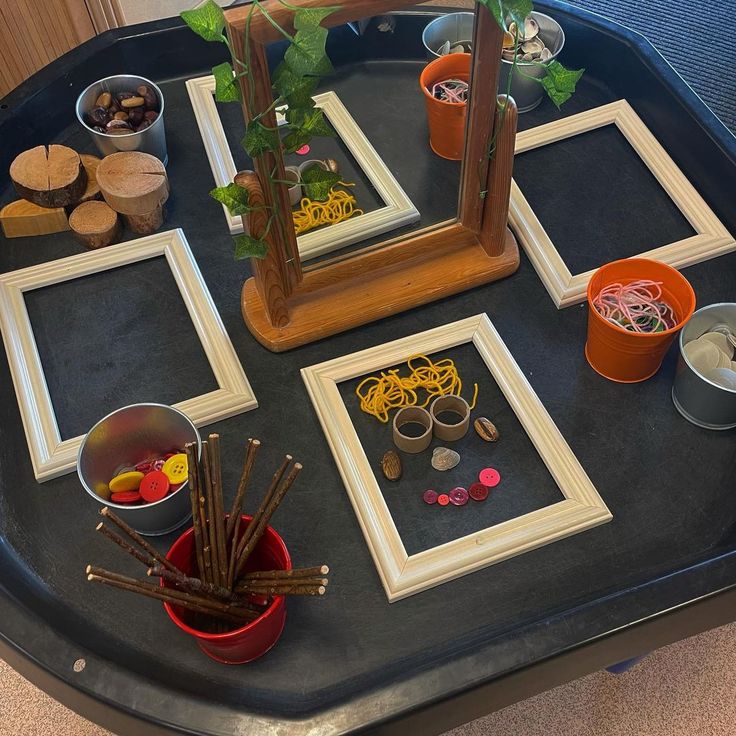 a table topped with pictures and bowls filled with candy sticks, candies and other items