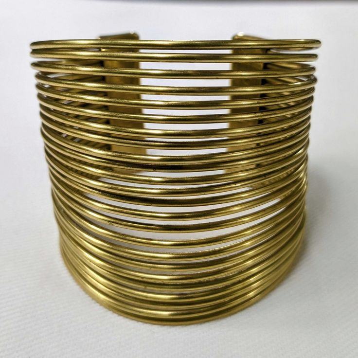 Chic Gold-tone Metal Bangle, Gold Bracelet Jewelry For Spring, Gold Spring Bracelet, Spring Gold Bracelet Jewelry, Antique Gold Adjustable Metal Bracelets, Trendy Gold Metal Bangle, Trendy Adjustable Gold-tone Cuff Bracelet, Adjustable Brass Bracelets For Party, Trendy Gold Cuff Bangle