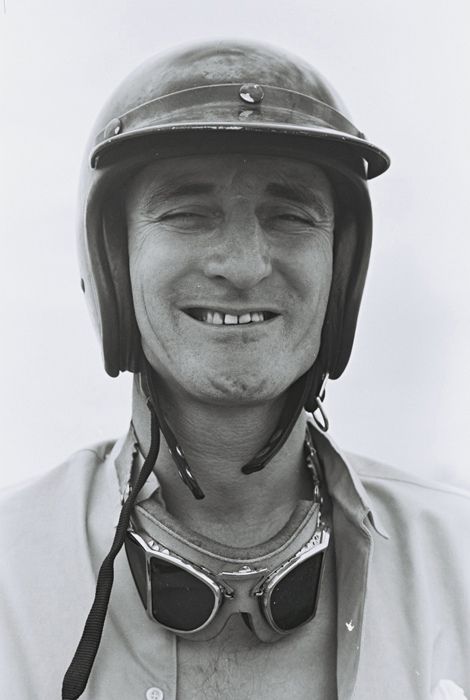 black and white photograph of a man wearing a helmet with goggles on his face