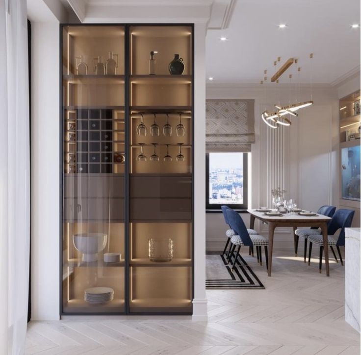 a dining room filled with lots of furniture next to a tall glass doored cabinet