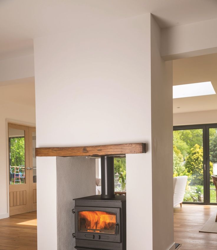 a wood burning stove sitting inside of a living room