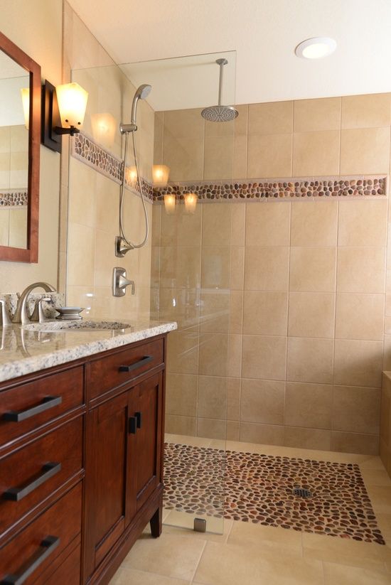 a bathroom with a walk in shower next to a sink