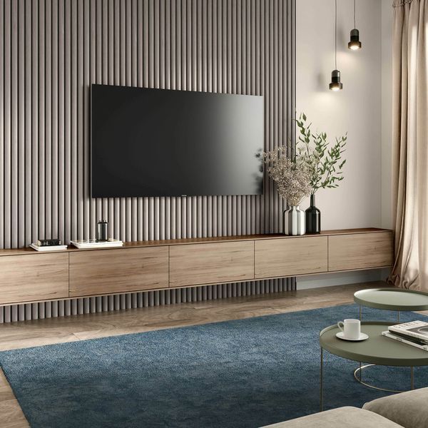 a living room with a large television on the wall