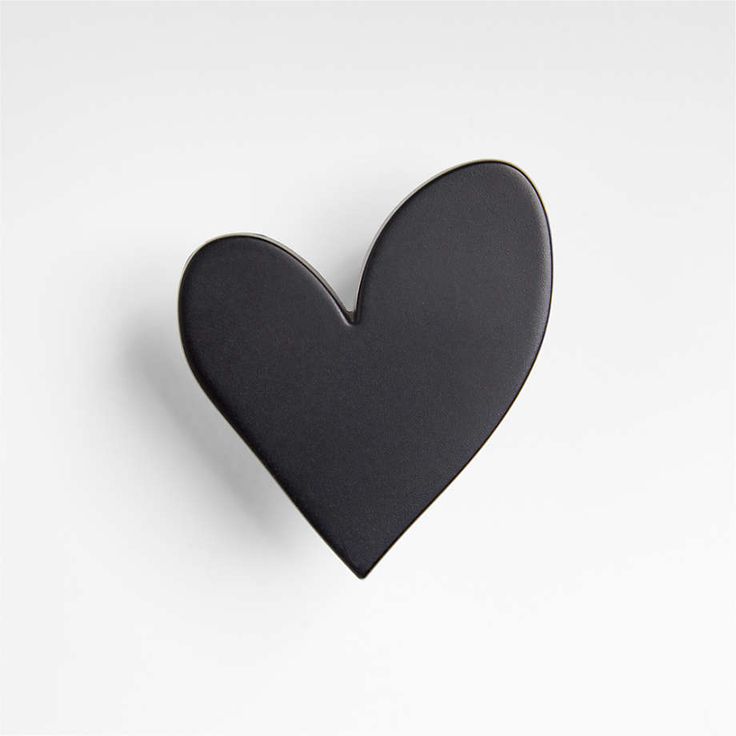 a black heart shaped object on a white background