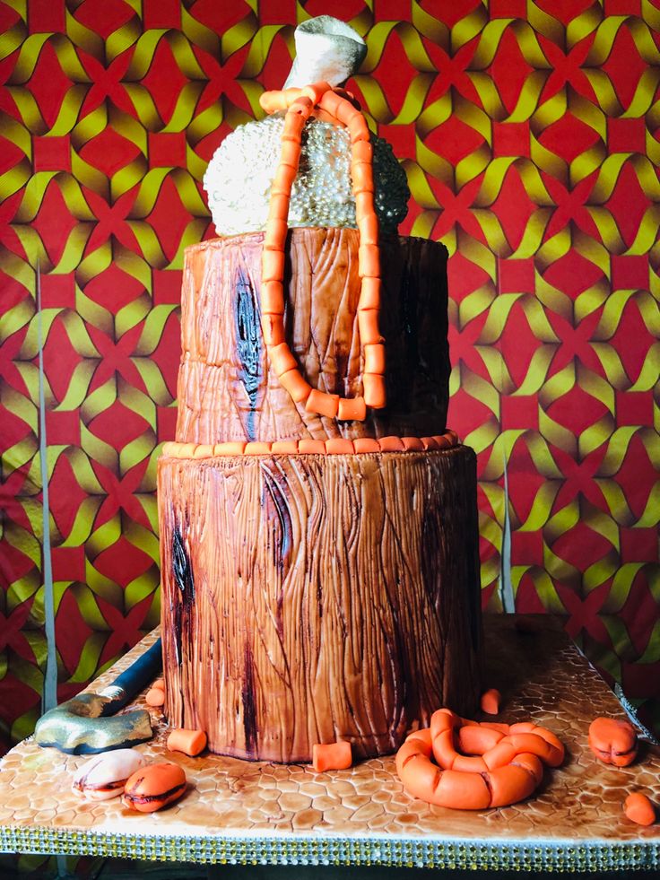 there is a cake made to look like a tree stump with orange decorations on it