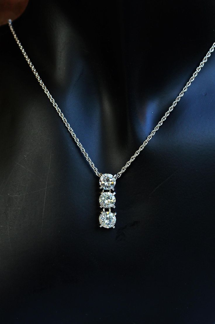 "Sterling silver CZ diamond pendant necklace setting with cubic zirconia first grade.  Trilogy silver pendant. Heart & Arrow diamond CZ superb grade.  Dainty dangling three piece diamond pendant made of sterling silver and plating with rhodium on silver for shiny and elegance look.   The pendant comes with option sterling silver double cable chain 16\", 18\" and more.  Nice and sturdy chain for everyday wearing. Materials   :  sterling silver, cubic zirconia, rhodium Chain         :  sterling silver double cable chain plating with rhodium Dimension  :  CZ 6.5mm x 3 pieces, Pendant 2.2 x 0.7 cm Weight        :   chain 2.6-3 grams <> All items come in individually gift box. It is ready to send as a gift for your special person. <> GIFT PURPOSES - We can also include a little card with a mess Silver Diamond Three Stone Necklace, Silver Three Stone Diamond Necklace, Silver Three Stone Diamond Necklace In Fine Jewelry Style, White Gold Cubic Zirconia Three Stone Diamond Necklace, Three-stone Cubic Zirconia Diamond Necklace In White Gold, Silver Three Stone Necklace, Fine Jewelry Style, Silver Three-stone Diamond Necklace Gift, Fine Jewelry Silver Necklace With Three Stones, Silver Three Stone Diamond Necklace Gift