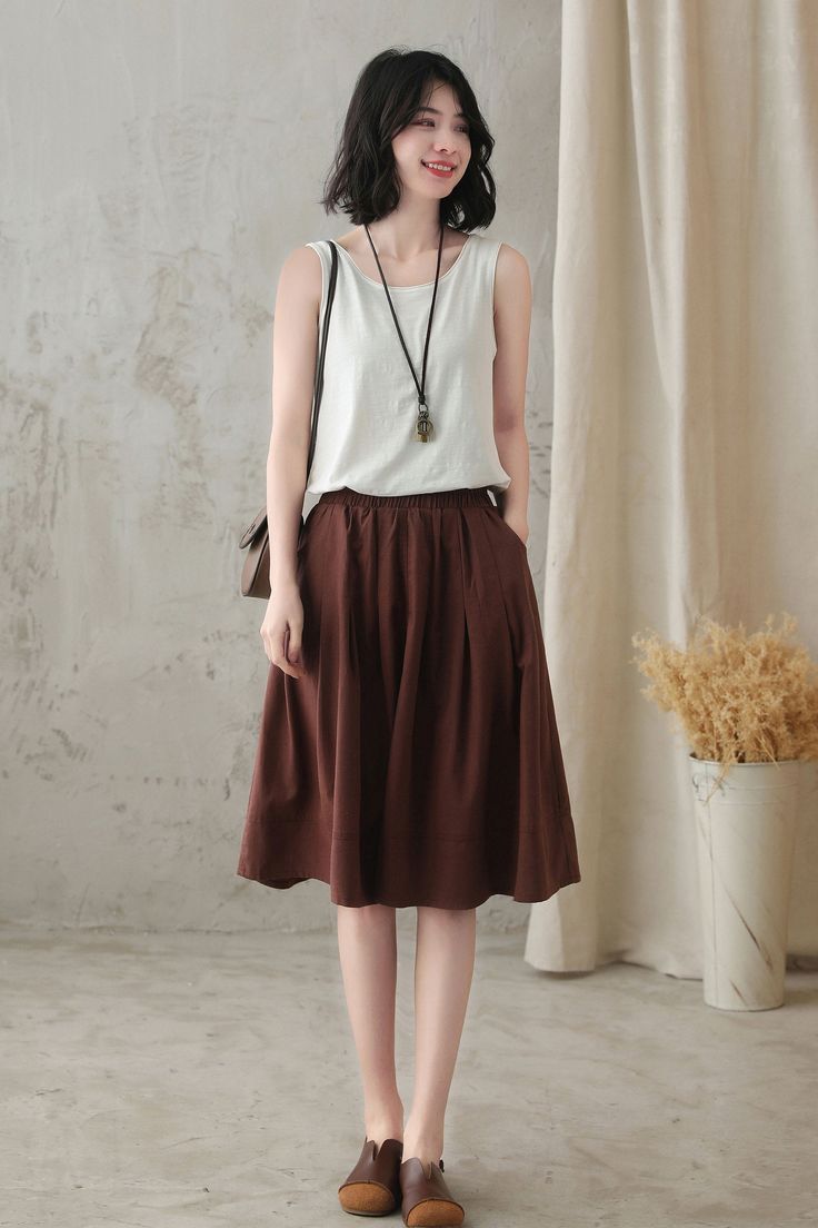 "DETAIL * 50% linen, 50% cotton * No lining * Two side pockets * Elastic waist * Knee Length * Circle skirt * Loose fit style * Perfect for summer, spring * Wash by hand or machine with cold water MODEL SIZE Bust:85 cm(33.4\") Waist:67 cm(26.7\") Height 5'7\" She wears size XS/S Choose CUSTOM Order if you * Need a better fit * Can't find your size in our size Chart * Change the Style * Chang the Length * Your Height is not Between 5'1\" - 5\"9\" SIZING AND FIT, Garment size as follow XS/S Length Long Wool Skirt, Dark Grey Skirt, Linen Midi Skirt, Water Model, Handmade Skirts, Women Skirt, Skirt Pleated, Wool Clothing, Spring Skirts