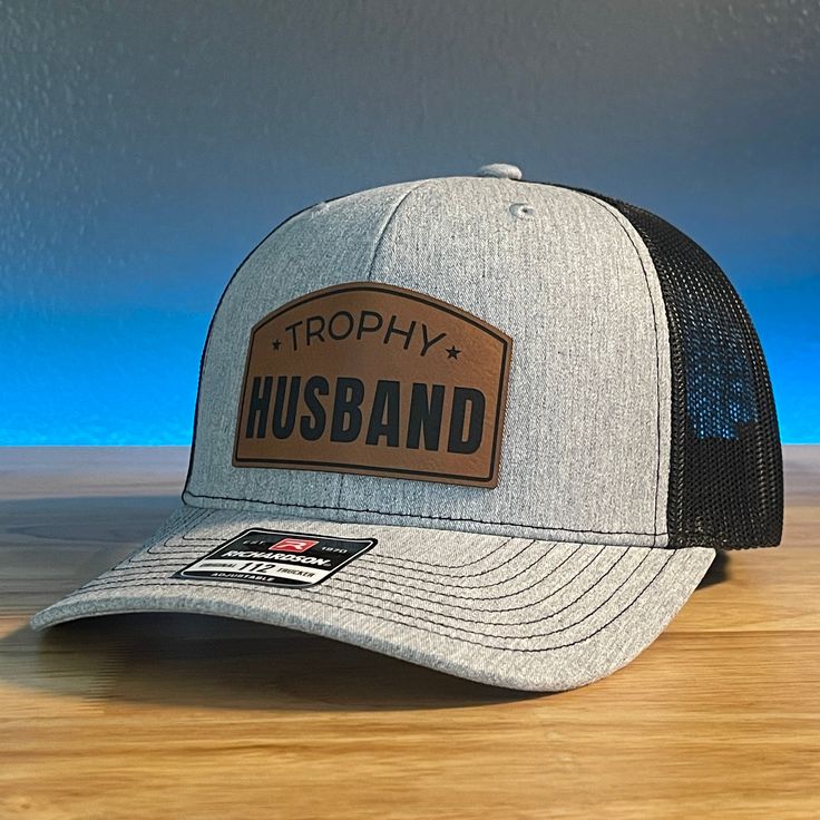 TROPHY HUSBAND Funny Leather Patch Hat. Specifications: 🧢 Richardson original 112 trucker; adjustable for the perfect fit 🎩 60/40 cotton/polyester blend for comfort 📏 One size fits most 🏷️ Expertly laser engraved leatherette patch design 📦 Ships in 2 to 3 business days from our Orlando Studio Care Instructions: 🚫 Do not wash; spot clean only Please Note: 🌈 Colors may vary from photos based on your viewing screen. Funny Hat Ideas, Orlando Studios, Trophy Husband, Husband Funny, Hat Bar, Leather Patch Hat, Cowboy Stuff, Patriotic Hats, Engraved Tumblers