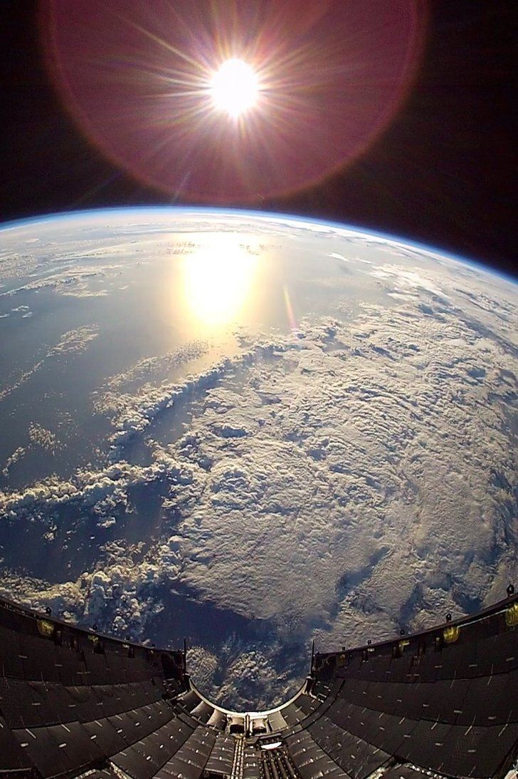 the sun is shining over the earth as seen from space