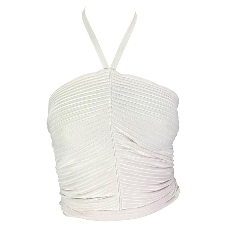 Presenting a form-fitting white Gucci cropped halterneck top, designed by Tom Ford. From the Spring/Summer 2000 collection, this ribbed top clings to the body. Featuring a seam down the front, this halterneck top naturally ruches and is made complete with a tie that wraps around the waist. Approximate measurements: Size - S Shoulder to hem: 15" Bust: 31" - 35" Waist: 24" - 30" (Can be tied even tighter) 83% Rayon Viscose, 17% Polyester Gucci Crop Top, Gucci By Tom Ford, Tom Ford Gucci, 00s Style, Silk Crop Top, Gucci Top, Gucci Brand, Halterneck Top, Gucci Outfits