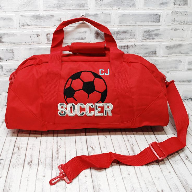 WHY THIS ONE IS SPECIAL: This personalized Soccer bag has black and white applique and gray accents, on a custom bag color. Perfect to to hold all your stuff whether for after school practice, competitions or even a weekend at grandma's! Add a name for a super personalized on the go bag. The HMTO Guarantee: Hand Made To Order means this product is not premade, so this item will be unique and hand crafted just for you! Current Production Times. THREE GREAT STYLES: TOTE bag measures 12x18"with a z Sporty Back To School Gym Bag, White Sports Bag For Back To School, Red Rectangular Sports Bag, White Sporty College Bags, Sporty Travel Bag With Embroidered Logo, Functional White Gym Bag For School, Functional Rectangular College Bags, Customizable White Bags For Sports Events, Functional Rectangular College Bag