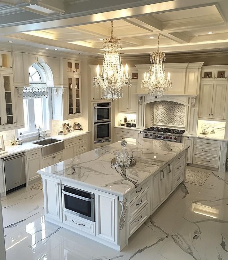 a large kitchen with marble counter tops and white cabinets, chandelier hanging from the ceiling