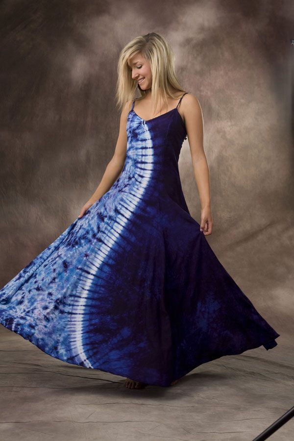 a woman in a blue and white tie dye dress