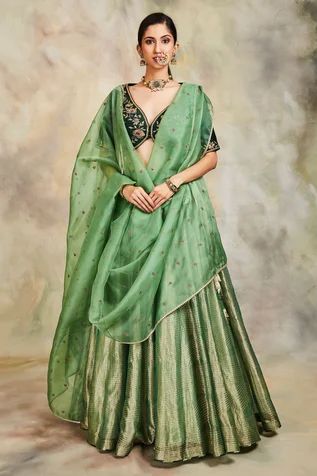 Green lehenga with all-over gold zari work. Comes with embroidered blouse and dupatta.
Component: 3
Embroidery
Neckline: V neck
Sleeve Length: Half
Fabric: Tissue, Raw Silk and Organza
Color: Green
Embroidered dupatta with lace trim edge
Side tie up with tassels
Closure: Hook front - Aza Fashions Raw Silk Lehenga, Organza Lehenga, Wedding Lehenga Designs, Lehenga Designs Simple, Green Lehenga, Half Saree Designs, Embroidered Lehenga, Indian Couture, Trendy Blouse Designs