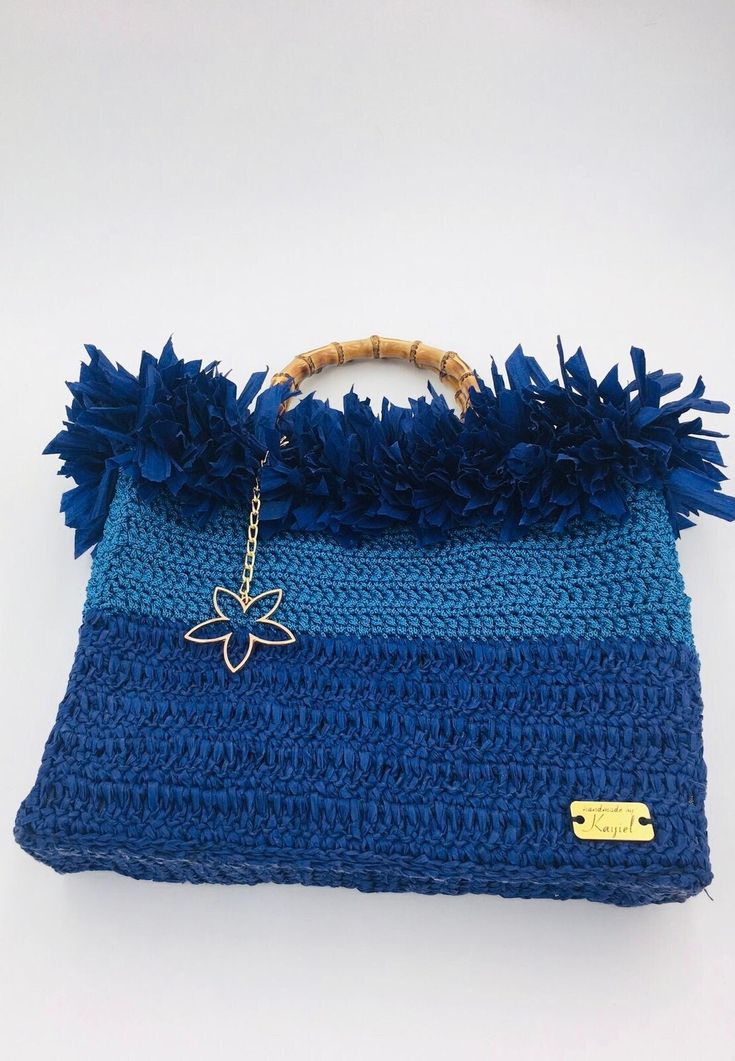 Handmade blue crochet handbag with raffia decor and bamboo handle. Fabric lining inside. Dimensions: 29cm x 32cm x 7cm Brand logo can be moved inside on request. Blue Top Handle Straw Bag For Travel, Blue Top Handle Straw Bag For Everyday Use, Blue Top Handle Shoulder Bag For Summer, Blue Crochet Bag With Top Handle For Everyday Use, Blue Handwoven Top Handle Bag, Blue Straw Tote Bag, Blue Crochet Travel Bag With Double Handle, Blue Straw Tote Shoulder Bag, Blue Handwoven Summer Beach Bag