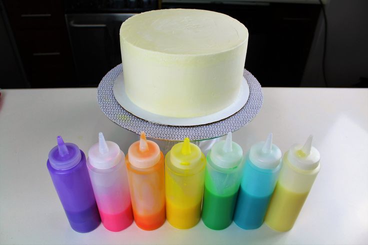 a cake sitting on top of a table next to bottles of condiments and a knife