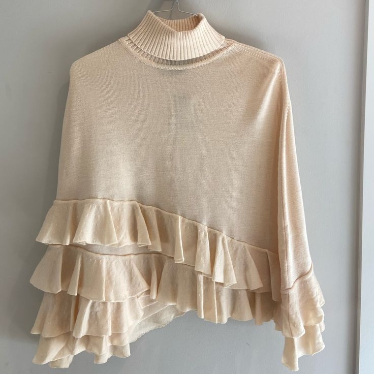 This Ivory Knit Ponch Is A Must To Elevate Any Outfit. Super Soft And With Details In End Fringe At Bottom Which Is Also Asymmetrical. Never Used Or Worn With Tags. One Size Beige Sweater For Layering, Beige Poncho For Layering, One-size Cream Sweater For Layering, One Size Cream Sweater For Layering, One Size Beige Poncho For Layering, Chic Beige Sweater In One Size, Chic One-size Beige Sweater, Chic Knit Poncho For Spring, Spring Beige Knit Poncho