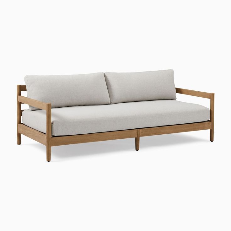 a wooden couch with two pillows on it