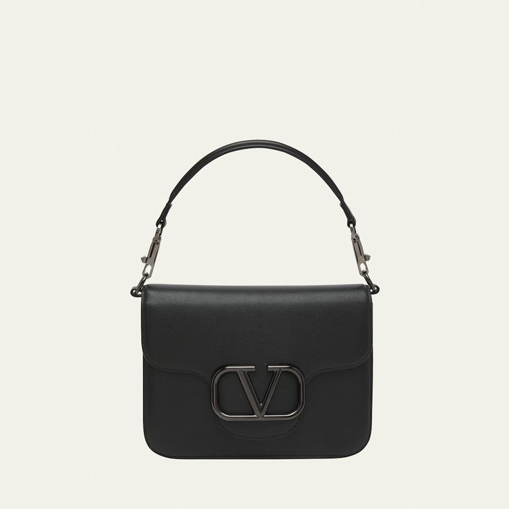 Valentino Garavani "Loco" shoulder bag in leather and metal  Detachable top handle  Detachable, adjustable crossbody strap Can be worn as a top handle or crossbody bag  Flap top with tonal VLOGO magnetic closure  Interior, one slip pocket  Lining: Leather Approx. 6.3"H x 8.7"W x 2.8"D Made in Italy Designer Flap Bag With Adjustable Strap, Designer Shoulder Bag With Detachable Strap For Everyday Luxury, Modern Flap Bag With Top Handle And Branded Hardware, Luxury Shoulder Bag With Detachable Strap And Round Handle, Designer Tote Flap Bag With Branded Hardware, Luxury Shoulder Bag With Adjustable Strap And Round Handle, Designer Flap Shoulder Bag With Detachable Strap, Designer Shoulder Bag With Round Handle And Adjustable Strap, Designer Satchel With Round Handle