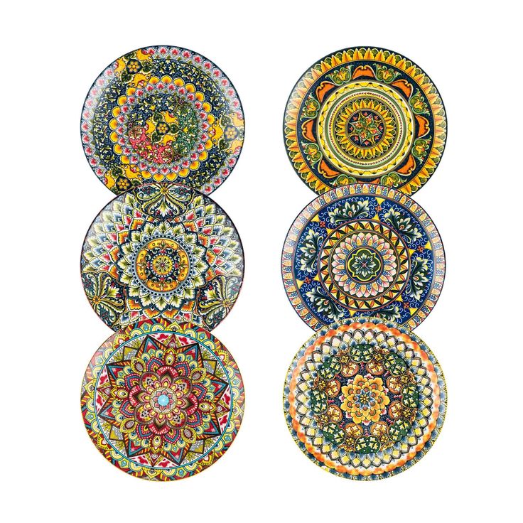 four plates with different designs on them, each painted in different colors and sizes to look like