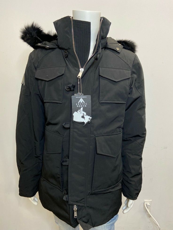 ARCTIC NORTH NWT MEN'S PARKA QUEBEC BLACK ON BLACK SIZE S Regular fit 100% Polyester Wind resistant shell and water proofed 80/20 white duck down 5 layers to insure warmth : shell/Baffle/Down/Baffle/Lining Genuine fox trim fur on hood Removable fur trim on hood Adjustable hood Arctic North metal logo on left sleeve. 2 way metal front zipper zipper on sleeve opening Buttons on front panel. Rib cuffs on sleeves 2 big front pockets with snaps 2 upper front snap pockets 1 inside zipper pocket Black Down Parka For Outdoor Activities, Black Down Puffer Parka, Black Waterproof Puffer Jacket For Cold Weather, Waterproof Black Puffer Jacket For Cold Weather, Black Duck Down Parka With Pockets, Black Duck Down Puffer Jacket For Outdoor, Black Down Parka With Pockets, Functional Black Down Parka, Black Windproof Down Puffer Jacket