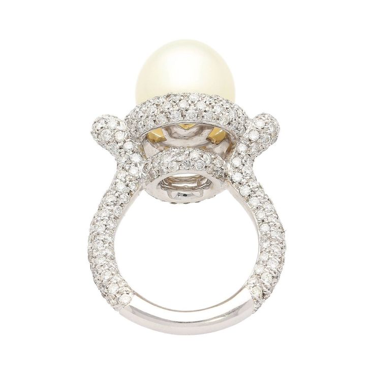 "12.3mm cultured Southsea white pearl and diamond pave set ring. Set in 18k white gold. The pearl is clean, lustrous, and very symmetrical. Adorned with 3.44 carats in natural diamonds and beautifully pointed edges above the shank.   Details:  - Metal: 18K White Gold - Size: 8  - Weight: 14.0 Grams Pearl Details: - Type: Cultured Southsea  - Size: 12.3 MM - Color: White - Luster: Excellent - Uniformity: Very good - Side Stones: 289 round cut diamonds, 3.44 carats, 1-1.5mm  SHIPPING TIMES: USA: 3 Luxury Stackable Round Pearl Ring, Luxury Diamond Pearl Ring With Pave Setting, White Pearl Diamond Ring With Pearl Drop, White Diamond Pearl Drop Ring, White Pearl Ring With Diamond, Luxury Pearl Rings With Diamond Accents, Luxury White Rings With Pearl Drop, Luxury Pearl And Diamond Ring With Brilliant Cut, Luxury Brilliant Cut Diamond Pearl Ring