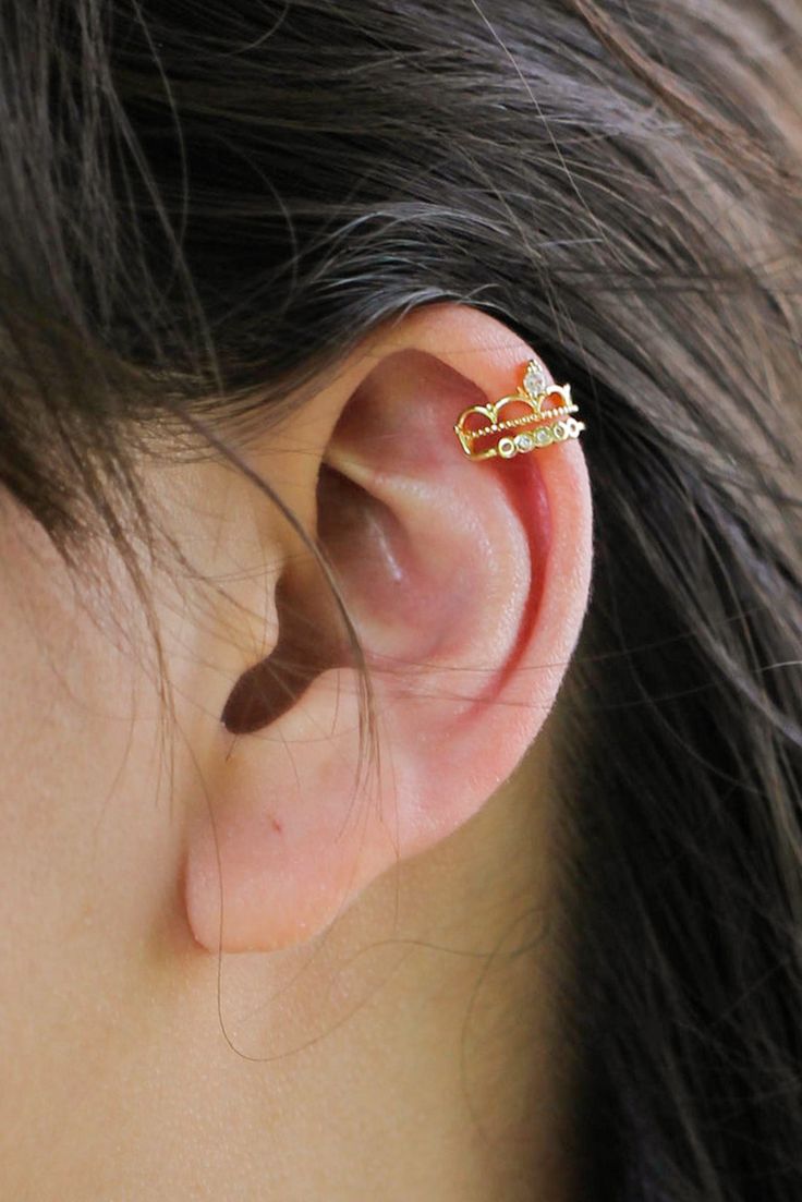 a close up of a person's ear with a small piece of jewelry on it