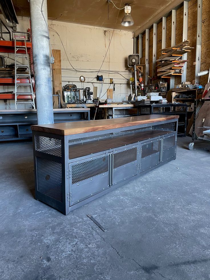 a large metal and wood counter in a building