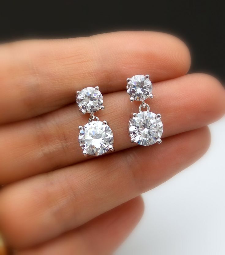 Tarnish resistant White gold plated metal framed AAA high quality clear white cubic zirconia round post earrings with AAA quality round drop clear white cubic zirconia pendant. Earring posts are surgical steel.. Size: top stone diameter: 6mm Bottom stone diameter: 8mm Matching necklace and bracelet available. https://www.etsy.com/listing/278176308/diamond-quality-solitaire-necklace-cubic?ref=listings_manager_grid https://www.etsy.com/listing/85607281/bridal-wedding-bracelet-christams?ref=shop_ho Simple Wedding Earrings, Small Earrings Gold, Diamond Charm Necklace, Round Diamond Earrings, Diamond Solitaire Earrings, Diamond Earrings Design, Solitaire Earrings, Jewelry Bridesmaid, Diamond Jewelry Designs