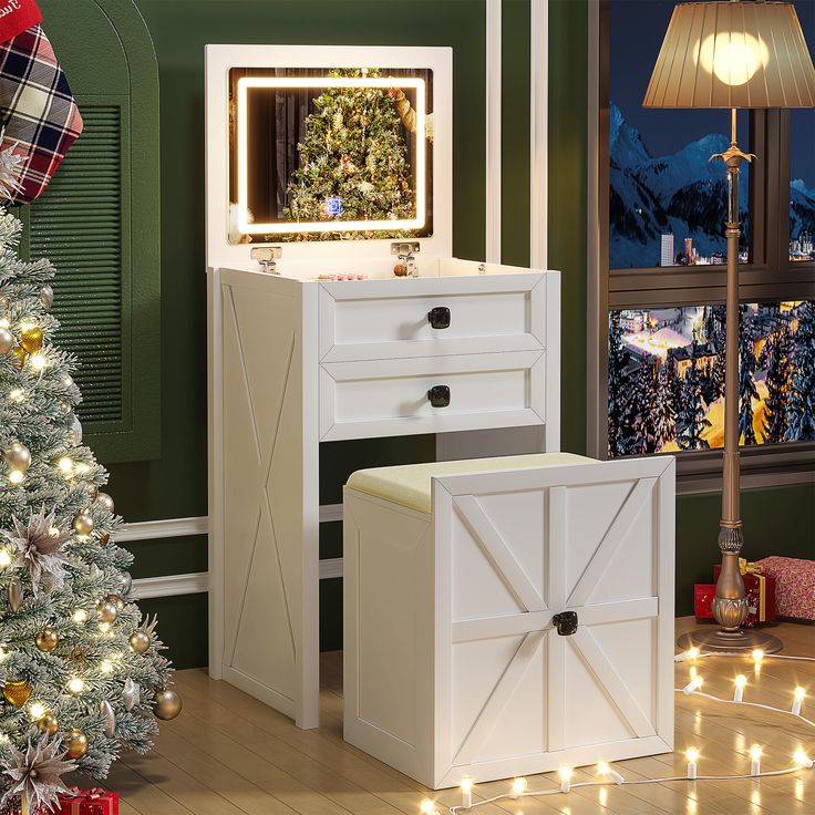 a christmas tree is in the corner of a room next to a dresser and mirror